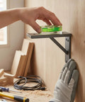 Bubble Level Vial, Spirit Level placed on a shelf bracket during leveling process, featuring a clear view and green color.