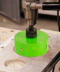 6-1/4 Inch Hole Saw With 6.25 Bit HSS Bi-Metal Cutter drilling into metal surface, shown with drill attachment