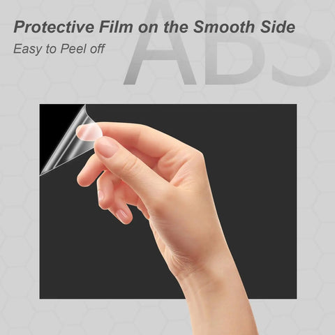 Hand peeling protective film from Two Pack Black ABS Plastic Sheets 8 By 12 Inches One Eighth Inch Thick Moldable Material For DIY Home Decor Handcraft Projects And Structural Crafts With High Tensile And Impact Resistance.