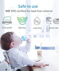 Infant drinking from safe, NSF 372 certified, BPA-free, lead-free bottle at table.