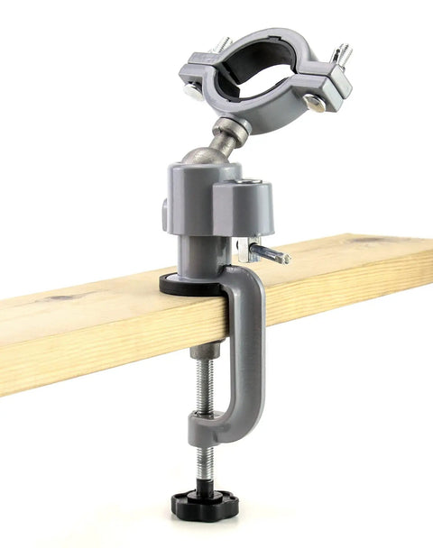 Sturdy Aluminum Alloy Bench Vise Clamp With Breezy 360 Spin And Quick 45 Degree Tilt securely clamped on a wooden plank.