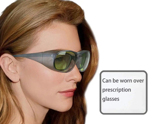 Heavy Duty Ipl Safety Glasses With Broad Spectrum Protection For Hair Removal And Beauty Therapy Lock In Zero Stress Eye Coverage For 200 To 2000 Nm Uv Rays And Blue Light Filters being worn over prescription glasses.