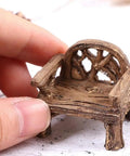 Close-up of miniature resin garden bench, part of Set Of 2 Miniature Resin Garden Benches For Fairy Village Dollhouse Decor.