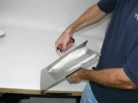 Person using Masonry Hawk With 13 Inch Aluminum Blade And DuraSoft Handle, callus preventer for plaster mud and mortar.