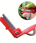 Thumb Knife And Pruning Shears For Leaf Trimming And Fruit Picking In The Garden Lightweight Snips With Precision Stainless Steel Blades And Ergonomic Grip For Easy One Hand Use Indoors And Outdoors Red, close-up view highlighting thumb usage.