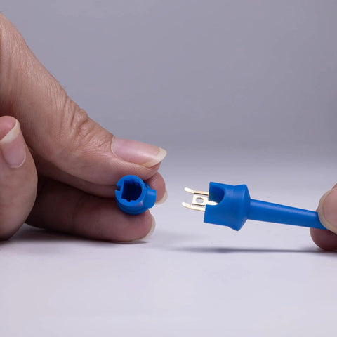 Blue nylon Insulated Test Hook Clip Set For Multimeter Lead Kit Mini Grabber Probes For Circuit Testing PCB ICs Safe Nylon6 Needle Durable Probes No Damage Secure Connection shown in hand.