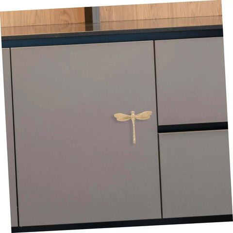 Dope Antiqued Brass Dragonfly Cabinet Knobs With Slick Pull Action For Kitchen Cabinets And Drawer Fronts on gray cabinet door.