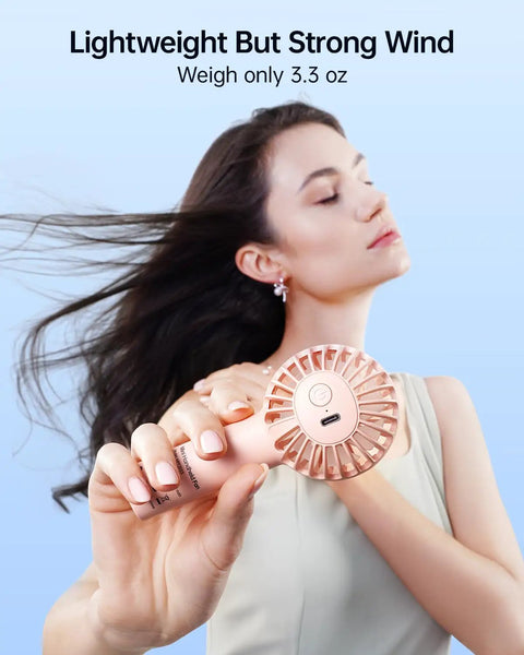 Mini Portable USB Rechargeable Handheld Fan, 3 Speeds, Cute Pink Travel Companion, woman enjoying breeze, close-up view