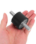 Four Piece Built For The Grind Anti Vibration Rubber Studs M10 Double Screw Mounts in hand showing cylindrical design.