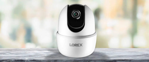Indoor WiFi Security Camera With Pan And Tilt 4MP HD Sensor 360 Degree Coverage on marble surface, front view