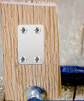 Flat Steel Mending Plate Bracket Set With Screws 20 Pack For Woodworking And Home Improvement attached to wooden board