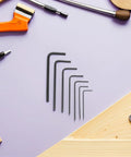 Top Notch 7pcs Mini Metric Hex Key Set From 0.7 To 3mm, Sturdy Metal Wrench Kit For Precision DIY Jobs And Quick Electronics Repair Without Breaking The Bank. 7 black hex keys on purple background