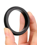 M48 To M42 Telescope Adapter With Knurled Aluminum Body Anodized Black Finish All Metal Construction held between fingers