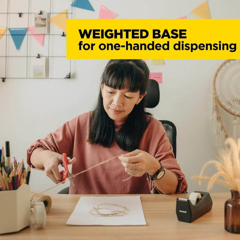 Woman using a black desktop tape dispenser, black polystyrene, weighted base, one-hand dispensing, refillable 1-in core
