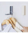 Slick Foldable Wall Hooks With Adhesive Backing For Space Saving No Drill Setup To Hang Jackets Purses Hats Or Dog Leashes In Foyer Closet Easy Install Design Works As A Lifesaver To Keep Home Clutter Free Always Two Pack on wall with hanging clothes.