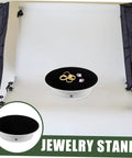 Premium Rotating Jewelry Display Stand With Smooth Electric Turntable Spin For Selling Accessories And Cosmetics on a dark velvet surface.