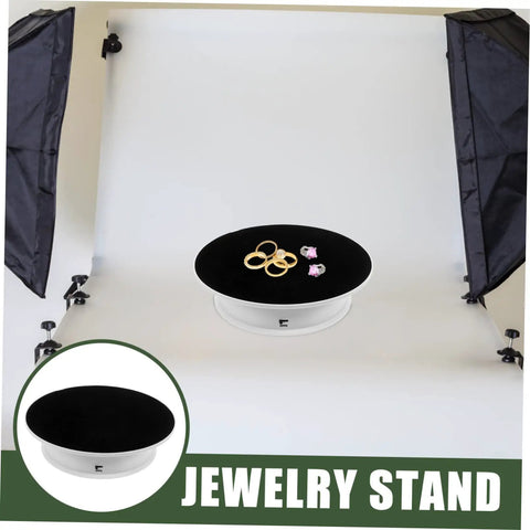 Premium Rotating Jewelry Display Stand With Smooth Electric Turntable Spin For Selling Accessories And Cosmetics on a dark velvet surface.