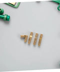 Brass Barrel Hidden Hinges For Small Jewelry Boxes displayed on a gray surface with surrounding green tools.