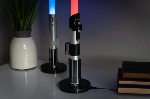 Darth Vader LED Lightsaber Lamp 24 Inch Tall Desk Night Light Star Wars Decor Red Blade on desk with books and vase