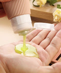 Dispensing liquid from TSA Approved Travel Bottles Set Three Ounce Silicone Squeeze Containers Leak Proof BPA Free