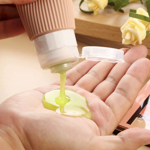 Dispensing liquid from TSA Approved Travel Bottles Set Three Ounce Silicone Squeeze Containers Leak Proof BPA Free