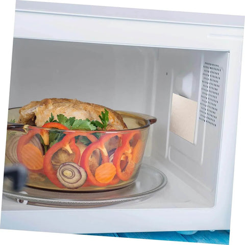 Microwave interior with installed mica plate sheet for waveguide cover, featuring a cooked dish, part of 20 Pieces Heat Resistant Mica Plate Sheets
