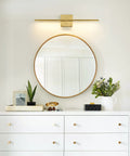 Gold Vanity Light Over Mirror 24 Inch LED 18W over round mirror above white dresser with plants