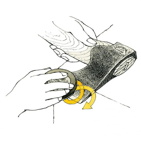 Illustration showing use of Dual Grit Ceramic Grinding Puck for axes sharpens and peels edges fast on axe blade.