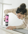 Woman using Pink Go To Cordless Drill Kit With 20V Battery And Charger 30 Nm Torque 21 Plus 1 Clutch Three Eighths Inch Keyless Chuck
