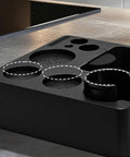 Built Tough Coffee Tamper Station And Espresso Organizer Box with predefined slots for 51mm, 54mm, 58mm baskets on kitchen counter.