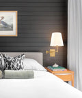 Gold Swing Arm Wall Lamp With Brass Finish And Linen Shade in bedroom setup, modern farmhouse sconces.
