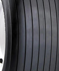 Close-up of Straight Rib Lawn And Garden Tire 13X5-6 Tire Only Rim Not Included with ribbed tread pattern for varied surface traction.