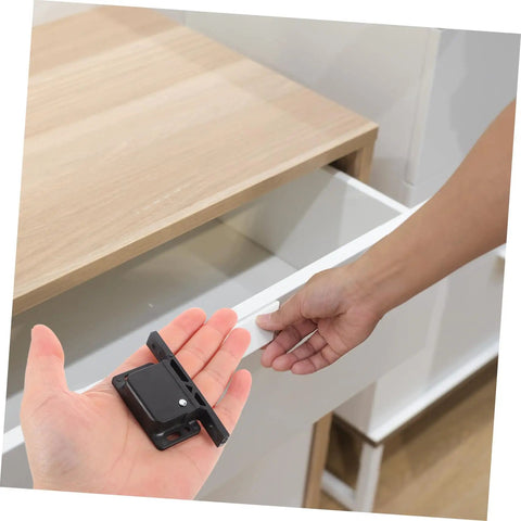 RV Compartment Latch Kit 4 Pack Durable Trailer Locks held near cabinet door, side mounted design in use for RVs and trailers.
