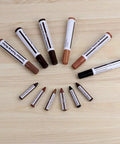 13 Piece Wood Repair Kit with markers and wax sticks for scratches and stains on wood surfaces, image showcasing contents on table.