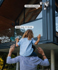 Child on shoulders with Wired Floodlight Security Camera With 2K Clarity, Outdoor Motion Sensor, 2600 Lumens mounted on house.