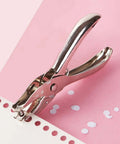 Single Hole Punch 1/4 Inch And 1/8 Inch, Workhorse Metal Paper Punch for crafts tags tickets, shown punching paper on pink background