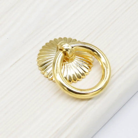 Close-up of 29mm Dope Gold Cabinet Ring Pull on wood, part of Set Of 6 For Dresser Drawers Wardrobes And Kitchen Cabinets Vintage European Style