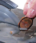 Close-up of 4 And 5 Inch Lapidary Trim Saw With Diamond Blades Included For Gems Minerals Crystals, stone being cut