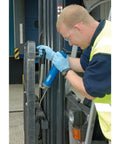Worker using Heavy Duty 500 CC Lever Grease Gun For Bulk Or Cartridge Loading on machinery, showing operation in industrial setting.