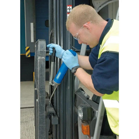 Worker using Heavy Duty 500 CC Lever Grease Gun For Bulk Or Cartridge Loading on machinery, showing operation in industrial setting.