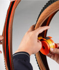 Applying Road Bike Tire Liner Self Adhesive Inner Tube Protector For 700c And 28 Inch Tires Puncture Proof Shield on bike wheel