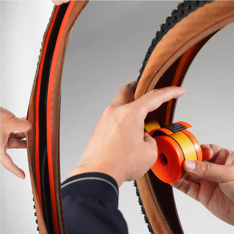 Applying Road Bike Tire Liner Self Adhesive Inner Tube Protector For 700c And 28 Inch Tires Puncture Proof Shield on bike wheel