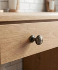 Close-up of wooden drawer with 4 Pack Brushed Zinc Alloy Cabinet Pulls Single Hole Drawer Handles For Kitchen Cabinetry.