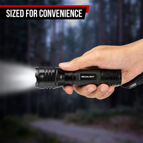 Hand holding Ultra Bright LED Flashlight Kit S1050 Two Pack With Adjustable Zoom And 3 Modes For Camping Hiking Dog Walking