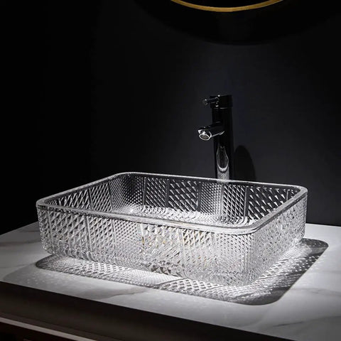 Square Clear Glass Vessel Sink Slick Finish Zero Hassle Cleanup Bathroom Vanity Basin Top Tier Modern Hotel Washbasin with polished copper drain on counter.