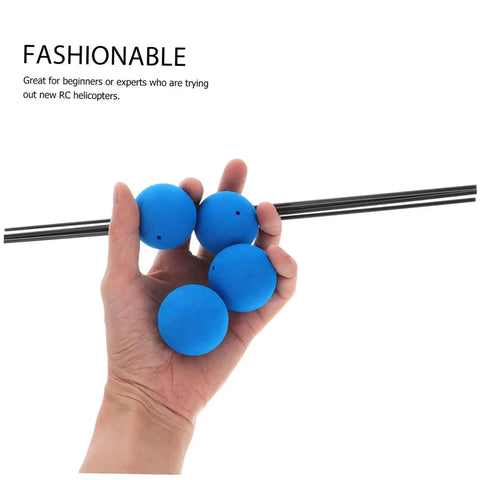 Hand holding RC Helicopter Training Gear Kit with blue sponge balls and rods for stability and flying practice beginner friendly accessories.