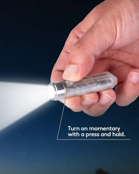 Hand holding Rechargeable Keychain Flashlight With USB C Fast Charge, 420 Lumens EDC Light shining in the dark