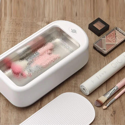 All In One Ultrasonic Glasses And Jewelry Cleaner 640ML 48KHz Powerful Sonic Cleaning Machine For Rings Gold Silver Eyeglasses And Dental Care Home Use on wooden surface with makeup brushes.