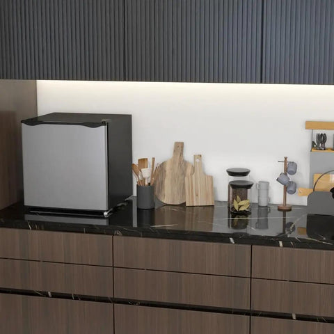 Real Deal 1.1 Cubic Foot Upright Mini Freezer With Quick Dial Thermostat on a kitchen counter with utensils.