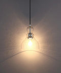 Two Pack Pendant Lights With 6.5 Inch Hand Blown Seeded Glass And Brushed Nickel Finish, illuminated glass pendant detail view.